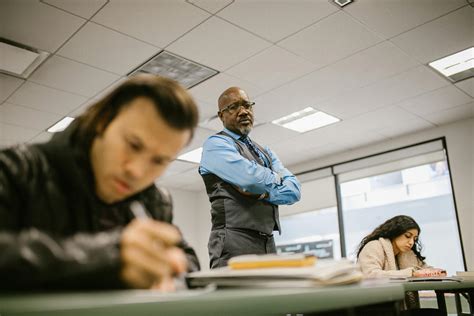 Teacher Proctoring His Students During An Examination · Free Stock Photo