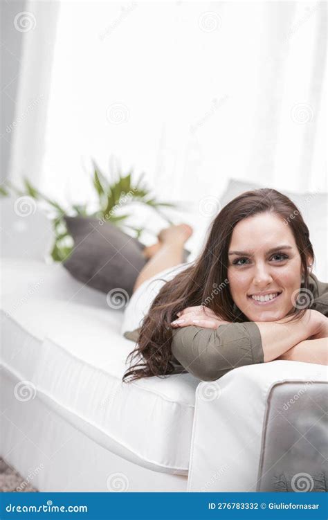 Smiling Woman Lying On Couch At Home Stock Photo Image Of Casual