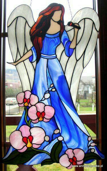 A Stained Glass Window With An Angel Holding A Microphone In It S Right