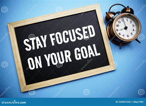 Stay Focused On Your Goal Word With Alarm Clock On Blue Background