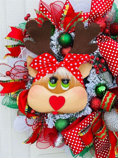 A Christmas Wreath With Reindeer Head And Red Bow