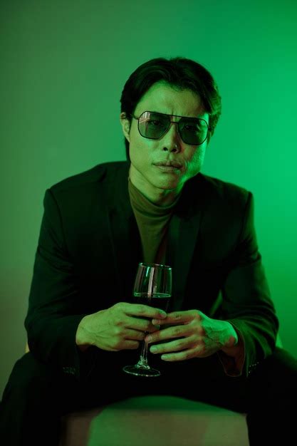 Premium Photo Frowning Man Holding Glass Of Wine