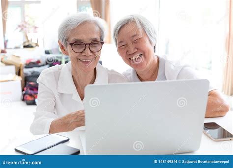 Happy Two Senior Asian Woman Sisters Or Friends Talking And Enjoying