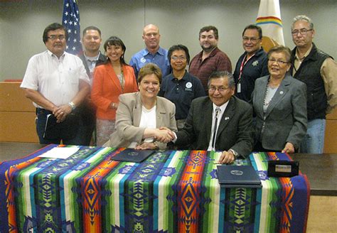 A Group Of Fema Representatives And Navajo Nation Members Together At A