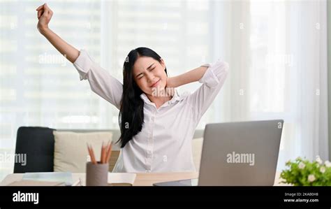 Beautiful Tired Young Asian Businesswoman Or Female Manager Stretching