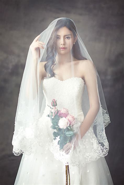 Woman In White Bridal Gown With Veil Holding Bouquet Of Flower HD