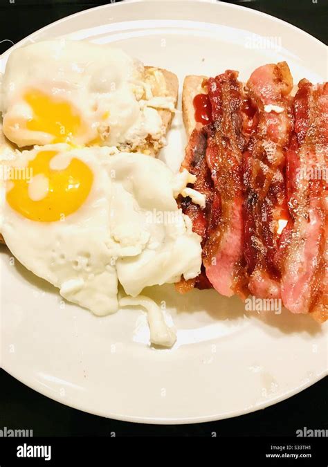 Breakfast With Fried Eggs And Crispy Streaky Bacon Stock Photo Alamy