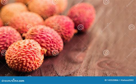 Fresh Organic Lychee Fruit On Brown Wooden Background Stock Photo