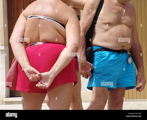 Half Naked Tourist In Bathing Suits On A Market In Alcudia On Mallorca