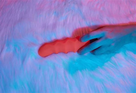 Premium Photo Desire Concept Woman Lying In Bed Holding A Dildo Vibrator In Her Hand To Help