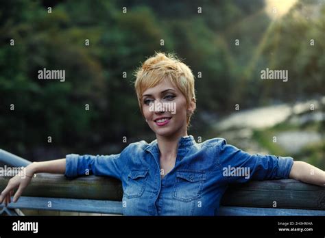 Portrait Of Beautiful Blonde Woman Leaning With Her Back And Arms