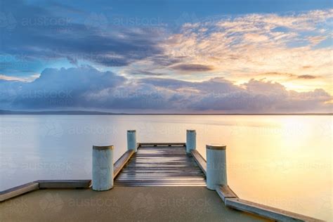 Image Of Wharf On Still Lake At Sunrise Austockphoto