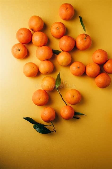 Orange Mandarins Clementine With Green Leaves On A Yellow Background