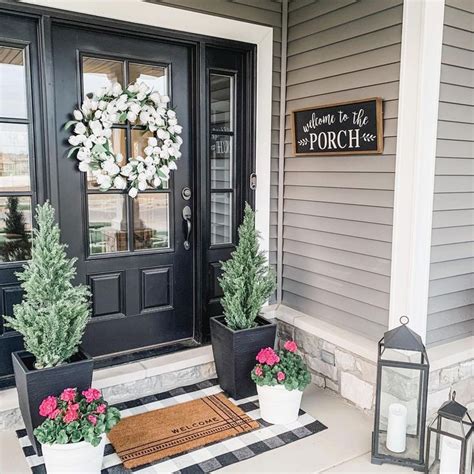 Two Potted Plants Are On The Front Porch