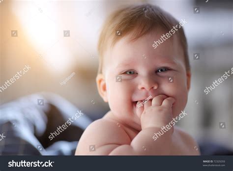 Portrait Of Smiling Happy 7 Month Old Baby Girl Indoors Closeup