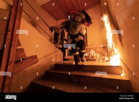 Brave Fireman Descends Stairs Of A Burning Building And Holds Saved