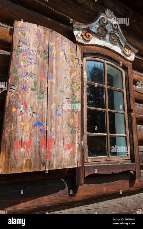 Traditional Wooden House With Folk Art Painted Shutters In The Open Air