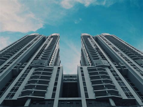 Free Stock Photo Of Two Tall Buildings With Balconies Against A Blue