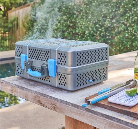 NOMAD Grill & Smoker portable charcoal barbecue is easy to carry ... 