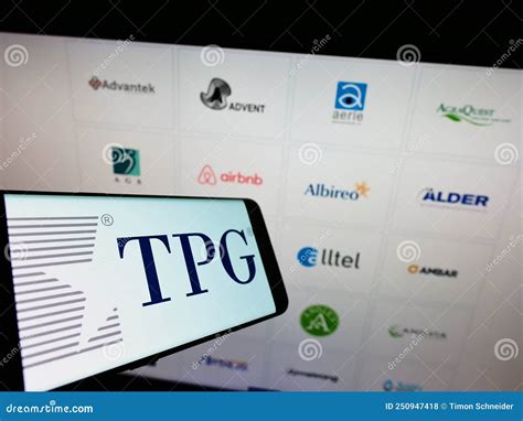 Smartphone with Logo of American Investment Company TPG Capital on Screen in Front of Business ...