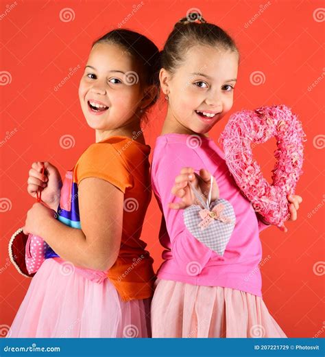 Children With Smiling Faces Stand Back To Back On Red Stock Image