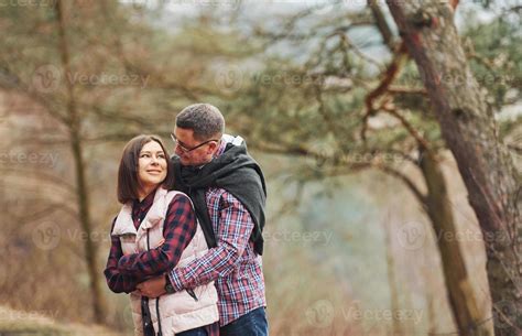 Happy Mature Couple Standing And Embracing Each Other Outdoors In