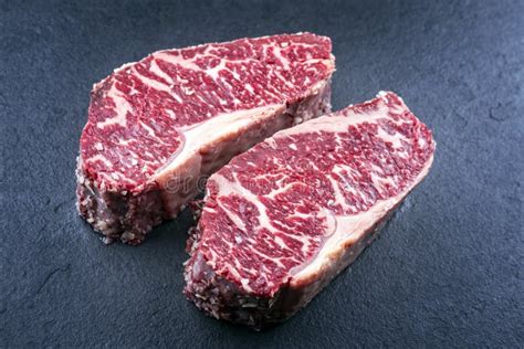 Raw Dry Aged Wagyu Roast Beef Steak on a Black Board Stock Photo ...