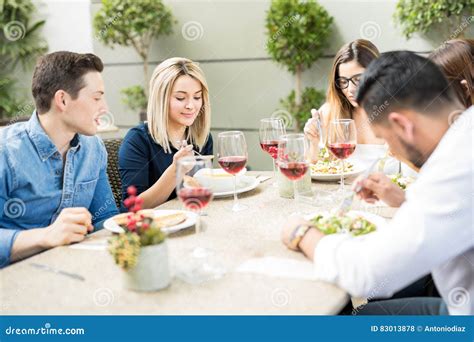 Group Of Friends Eating In A Restaurant Stock Photo Image Of Meal