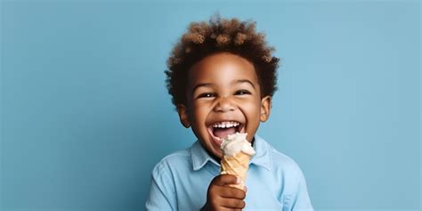 Cheerful African American Boy Eating Ice Cream On Blue Background