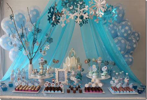 A Table Topped With Lots Of Cakes And Desserts Covered In Blue Paper