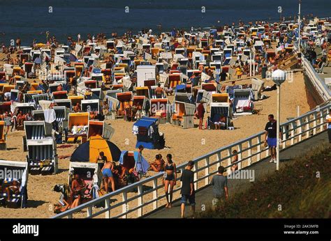 Spa visitors enjoy the summer weather on the beach of Westerland in ...