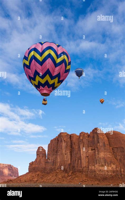 Three Hot Air Balloons In The Monument Valley Balloon Festival Fly Over