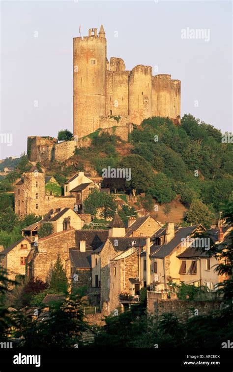 The Castle Towering Above Village Houses In Early Morning Light Najac