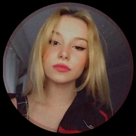 A Woman With Blonde Hair Is Looking At The Camera