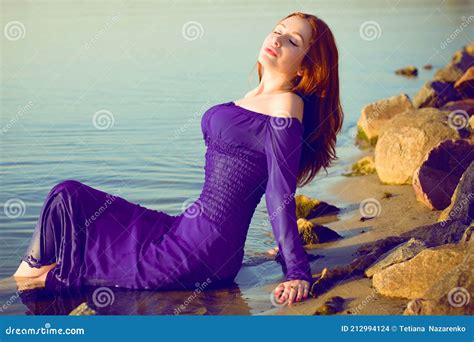 Woman In Purple Long Dress At Nature Fashionable Concept Stock Photo