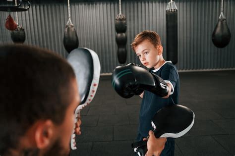 Premium Photo | Practicing together coach is teaching the boy box ...