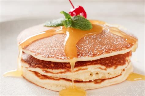 Premium Photo | American pancakes with honey topping