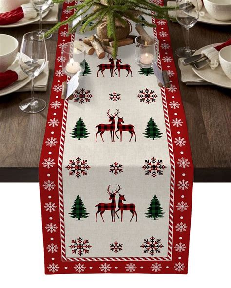 A Christmas Table Runner With Deers And Snowflakes On It