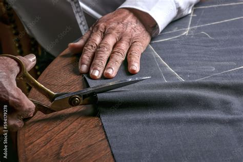 A Tailor Cutting A Cloth According To The Tradition Of Tailors The