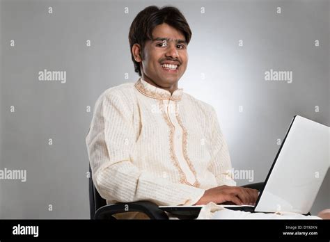 Man using a laptop and smiling Stock Photo - Alamy