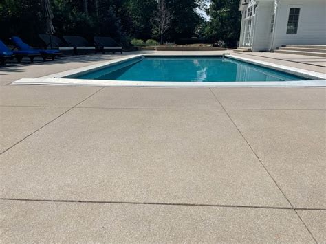 Sand finish pool deck | Colored concrete patio, Pool decking concrete ...