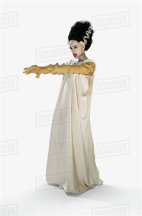 Woman Dressed As The Bride Of Frankenstein Halloween Costume Holding