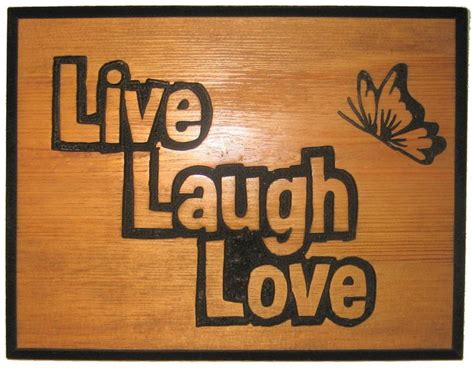 a wooden sign with the words live laugh love and a butterfly on it that ...