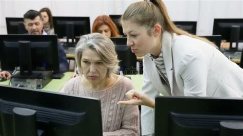 Computer Lessons For Adults Group Of Senior People Learning To Use