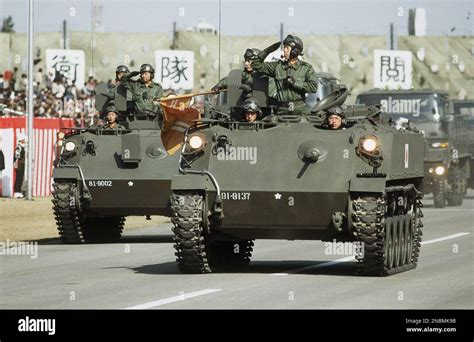 Japan’s ground self-defense forces military parade goes past a ...