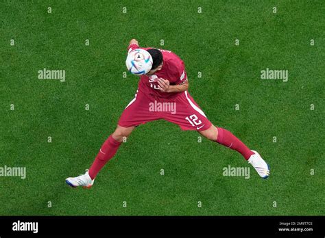 Qatar S Karim Boudiaf Heads The Ball During The World Cup Group A