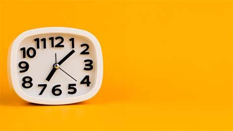 Premium Photo Alarm Clock On Yellow Background Time Concept