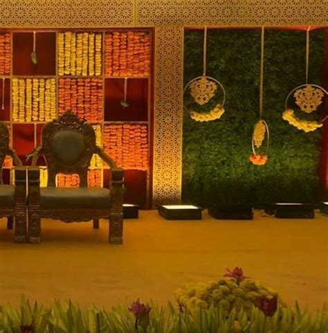 Traditional Marigold Backdrop with Green Wall for Indian Wedding Decor