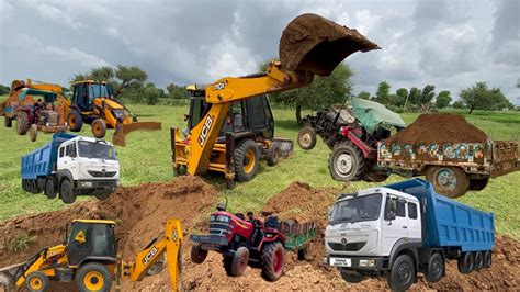 Jcb Dx Backhoe Loading Red Mud In Tata Truck And Tata Dump Truck