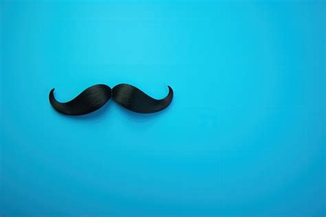 Premium Photo A Black Moustache On A Blue Background